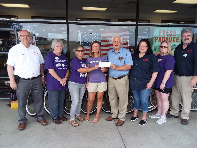 Check presentation attendees shown are (l-r) Ron Holloway, Hocker's Super Center Clarksville manager; Donna Blanchard, cashier, who sold 624 forget-me-nots; Vivian Goodman, Walk to End Alzheimer's committee member; Aimee Isaac, advocacy committee chair; Sen. Gerald Hocker, R-Ocean View, G&E Hocker's Supermarkets owner; Dawn Myers, top cashier, who sold 771 forget-me-nots; Candy Giblet, cashier, who sold 352 forget-me-nots; and Mike Workman, G&E Supermarket Ocean View manager. SUBMITTED PHOTO